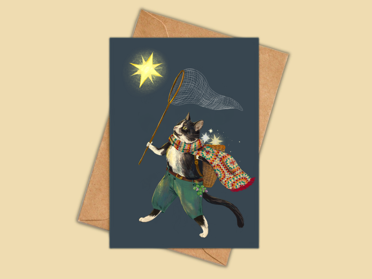 Greeting card with a cat illustration holding a fishing net on a dark blue background, with a brown envelope.