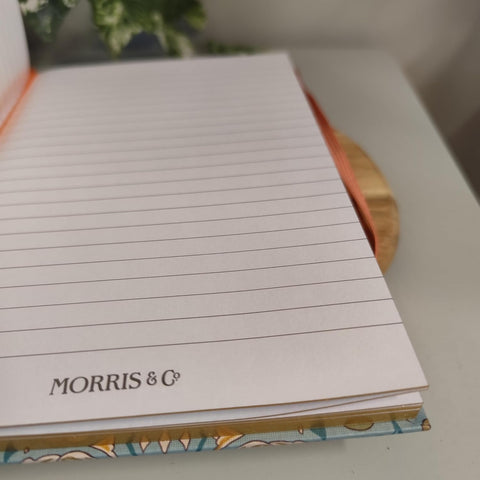 Notebook with lined pages and 'Morris & Co' branding on a blurred background