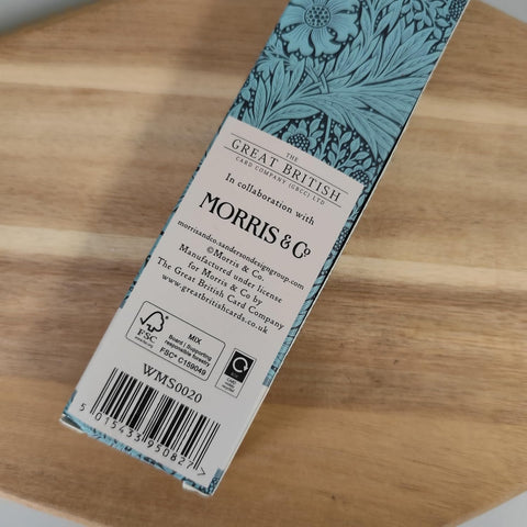 Product packaging with floral design and text on a wooden surface