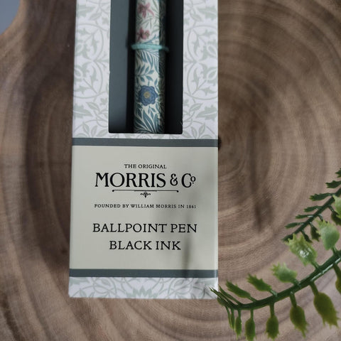 Ballpoint pen with black ink in packaging on a wooden surface