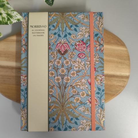 Floral notebook with a decorative cover on a wooden surface