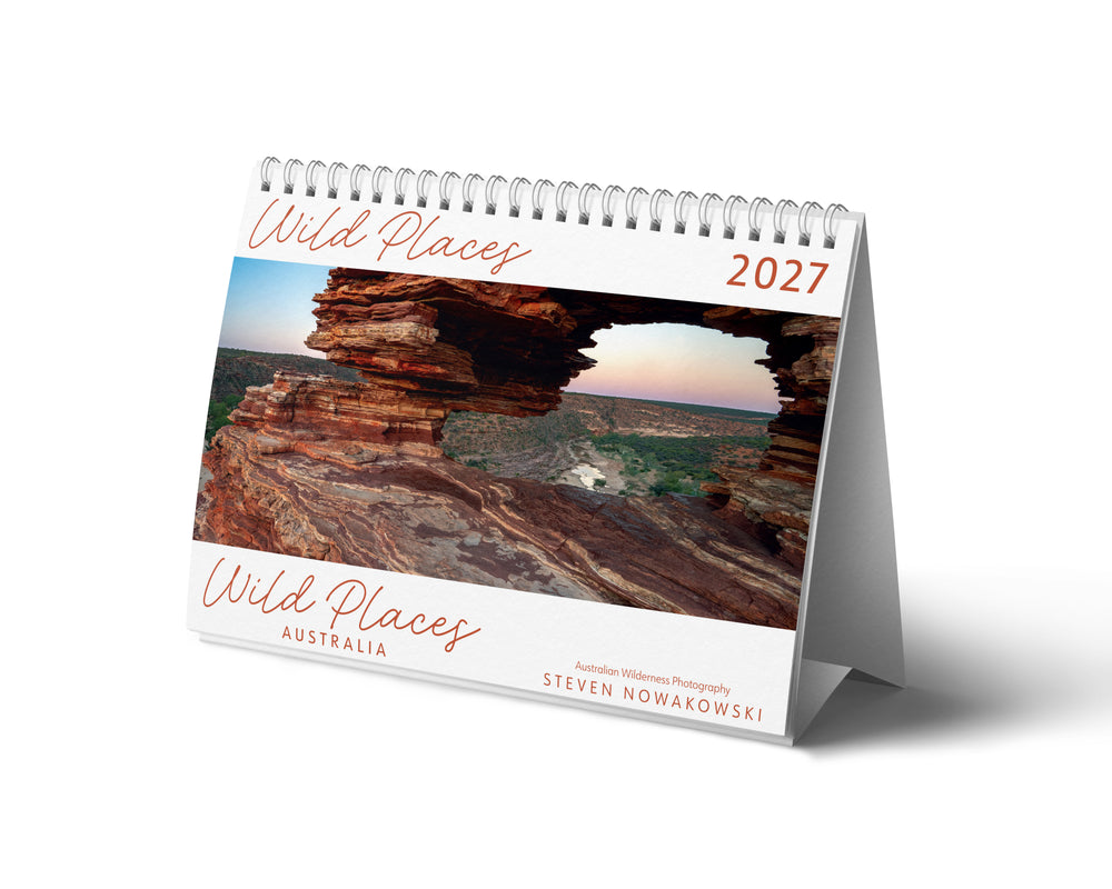 Desk calendar titled 'Wild Places 2021' featuring a scenic view of a cave entrance.