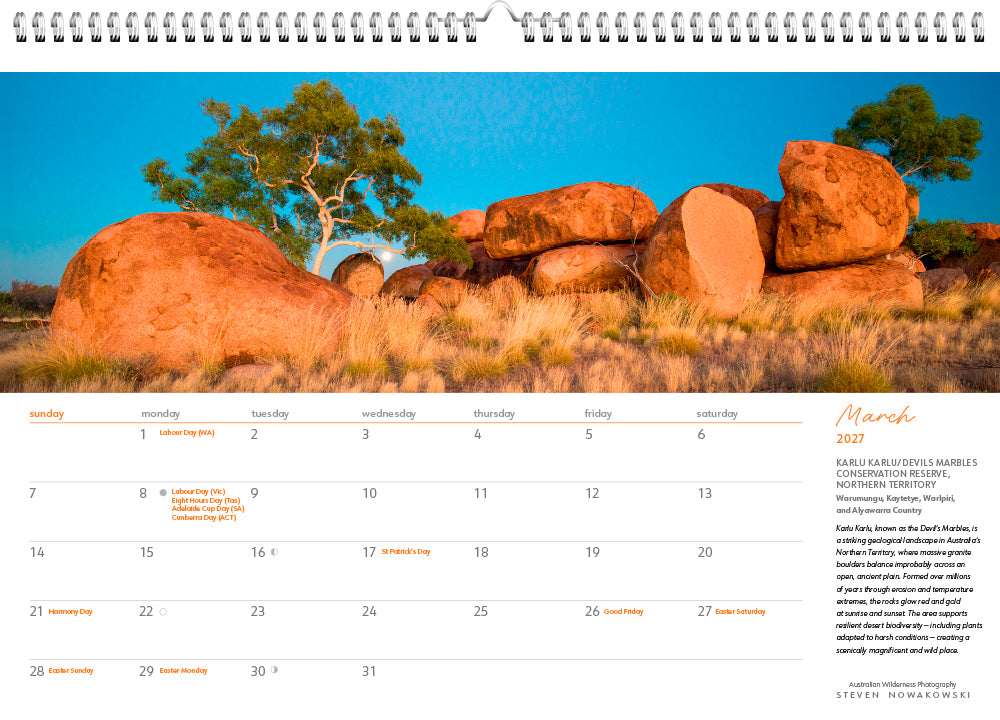 March calendar page with an image of grass, ocks and trees with a blue background.