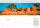 March calendar page with an image of grass, ocks and trees with a blue background.