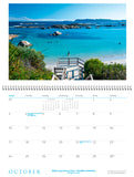 October page of calendar with a photo of a sheltered beach with a jetty and rocks.