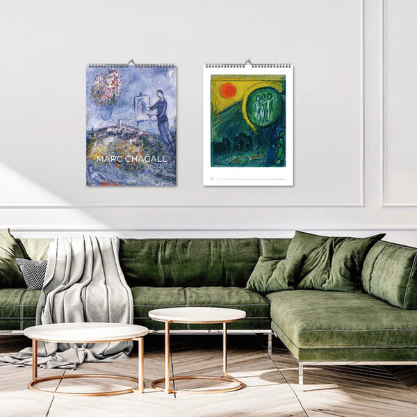 Two Marc Chagall artworks on a wall above a green sofa in a living room.