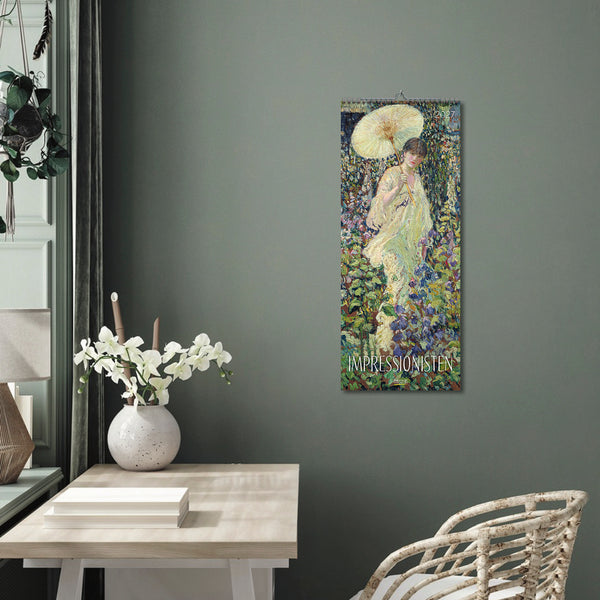 A room with green walls and a large Impressionist calendar hanging on the wall