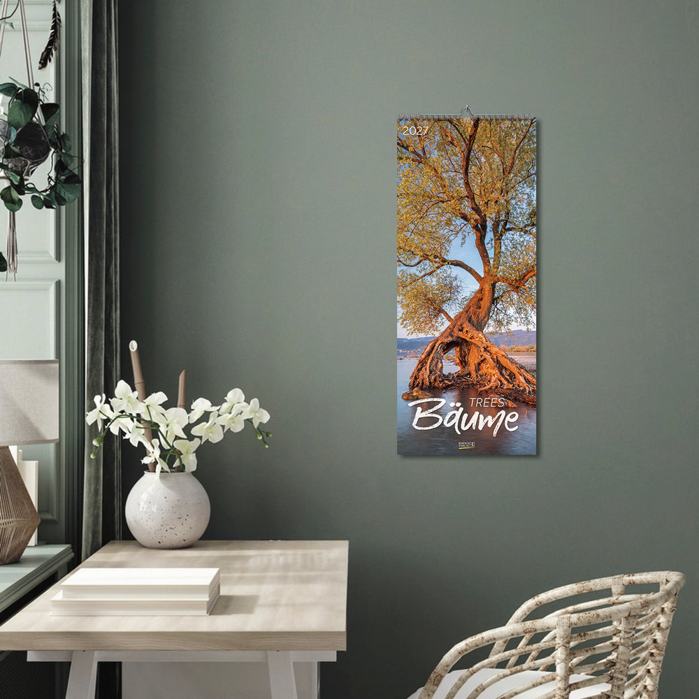A room with green walls and a large Baume calendar on the wall.