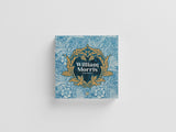 Decorative book cover with floral patterns and 'William Morris' branding on a light gray background