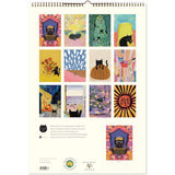 Spiral-bound calendar with colorful cat illustrations on a white background