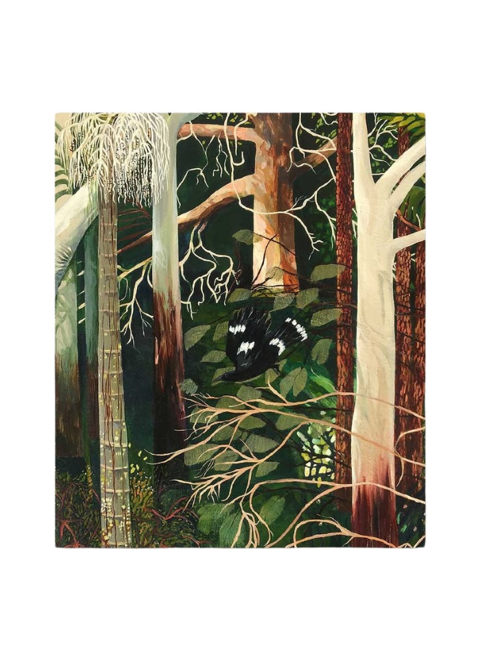 A forest of trees with a black and white bird diving down.