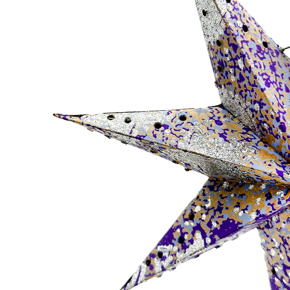 Decorative star-shaped object with purple and gold pattern on a white background