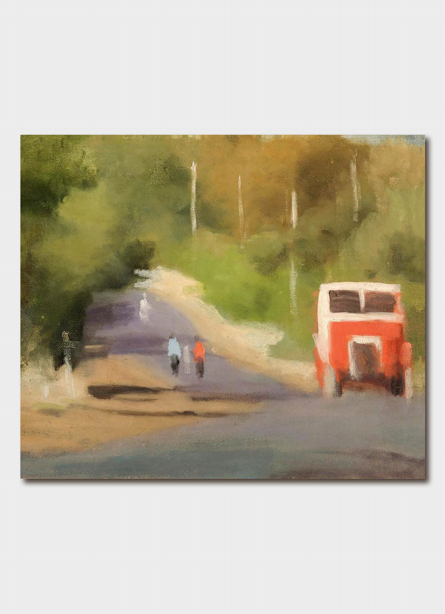 Red Bus on a road with 2 people walking near it.