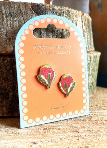 Enamel earrings on a Braw Paper Co. card with wooden background