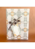 Gift wrapped in decorative paper with a branch on a brown surface