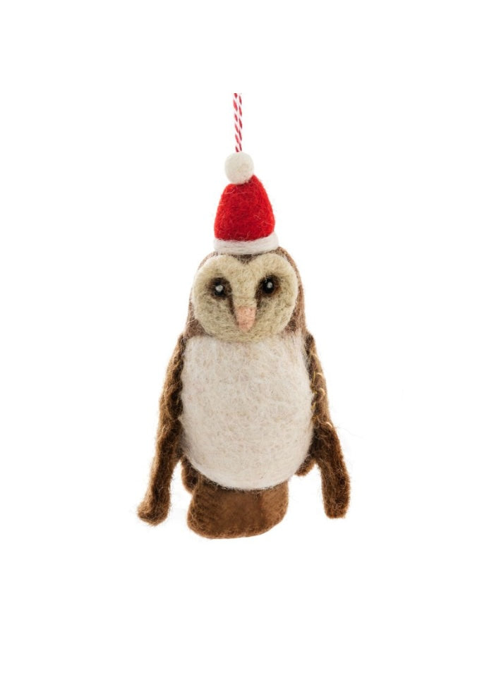 Plush owl toy wearing a Santa hat on a white background