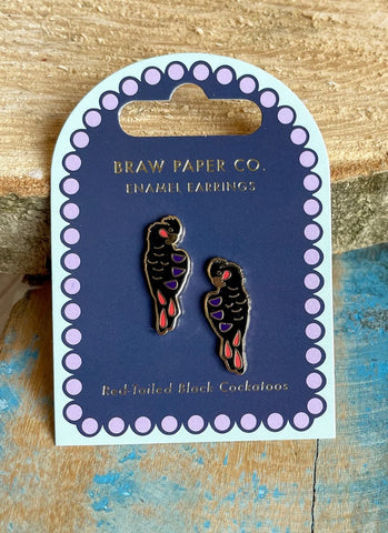 Enamel earrings on a Braw Paper Co. card with a wooden background