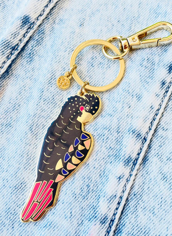 Keychain with a parrot design on a denim background