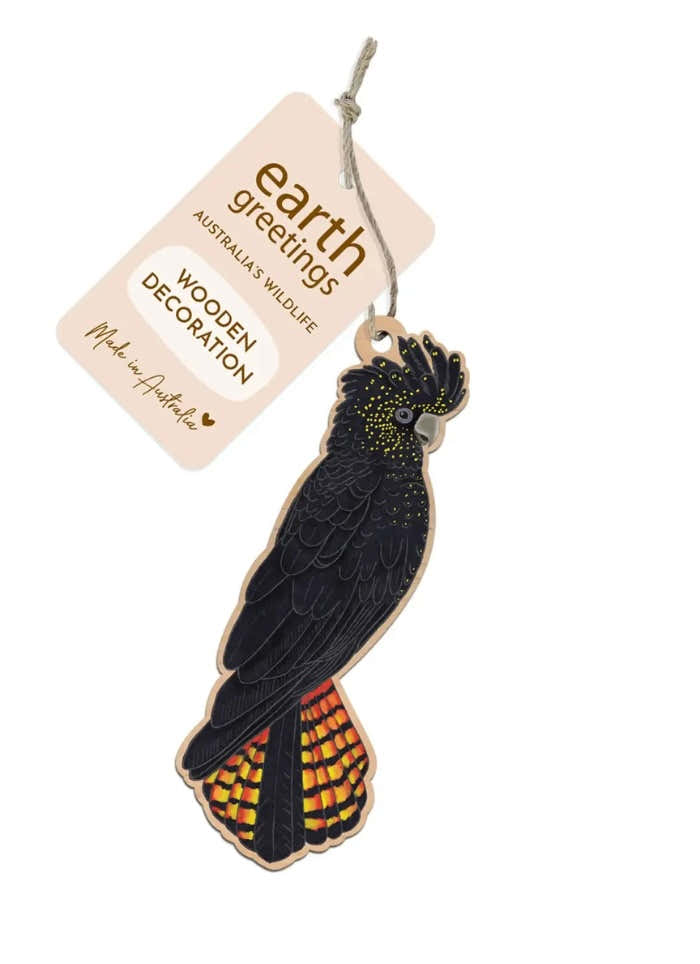 Wooden parrot decoration with 'earth greetings' tag on a white background
