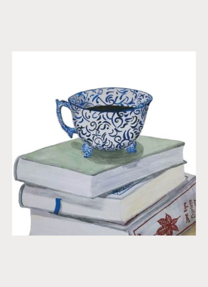 Cup of tea on top of a pile of books.