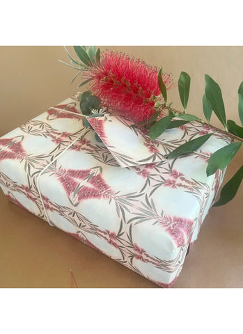 Floral-patterned box with a pink flower and green leaves on a beige background