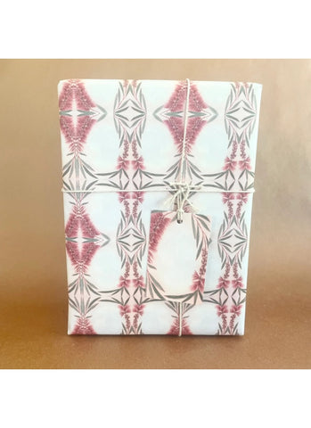 Notebook with geometric pink and gray pattern on a brown background