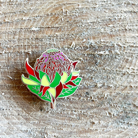 Colorful flower-shaped pin on a wooden surface