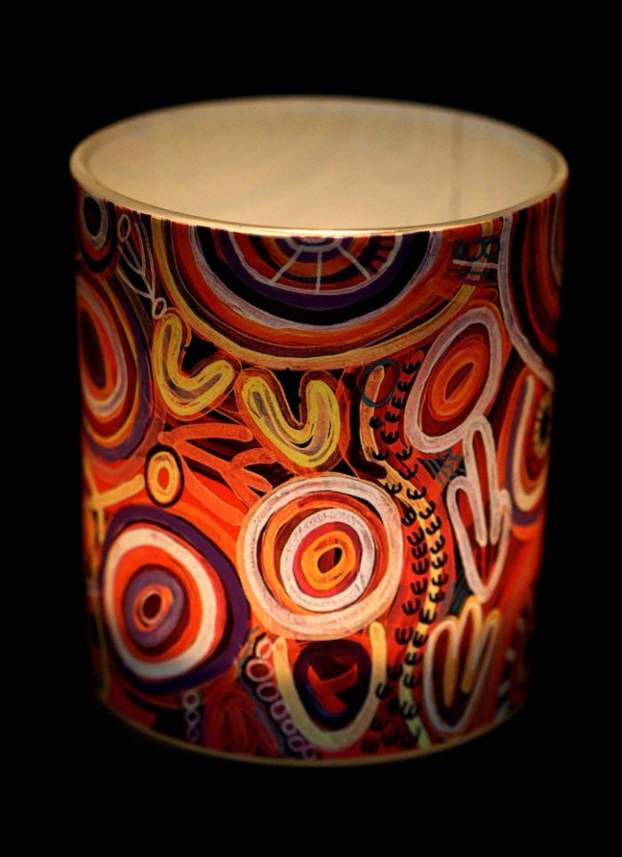 Colorful cylindrical container with abstract patterns on a black background