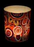 Colorful cylindrical container with abstract patterns on a black background
