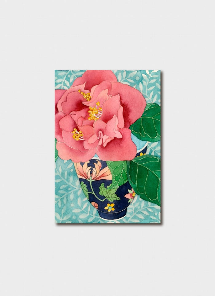 Gift card with a pink camelia in a floral teacup on a green background