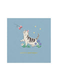 A square light blue birthday card featuring an illustration of a white tabby cat chasing a pink butterfly, with small flowers, yellow stars, and the text 'HAPPY BIRTHDAY' in gold at the bottom.