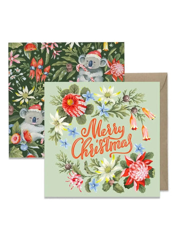 Christmas card with koala and floral design, featuring a green envelope.