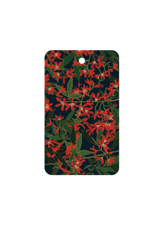 Rectangular card with red floral pattern on a dark background