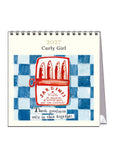 2027 Curly Girl desk calendar with sardine can illustration on a checkered background