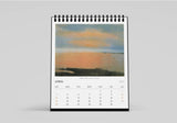 Calendar with a scenic cover on a light gray background