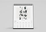 Calendar with black and white illustrations of dogs on a gray background