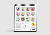 Desk calendar with illustrations of birds and teacups on a white background