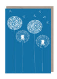A mid blue background with white dandelion flowers