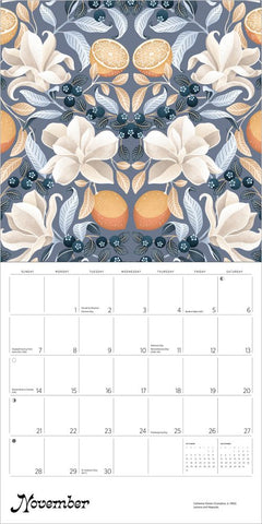 Calendar with floral and fruit design, featuring oranges and blueberries on a gray background.
