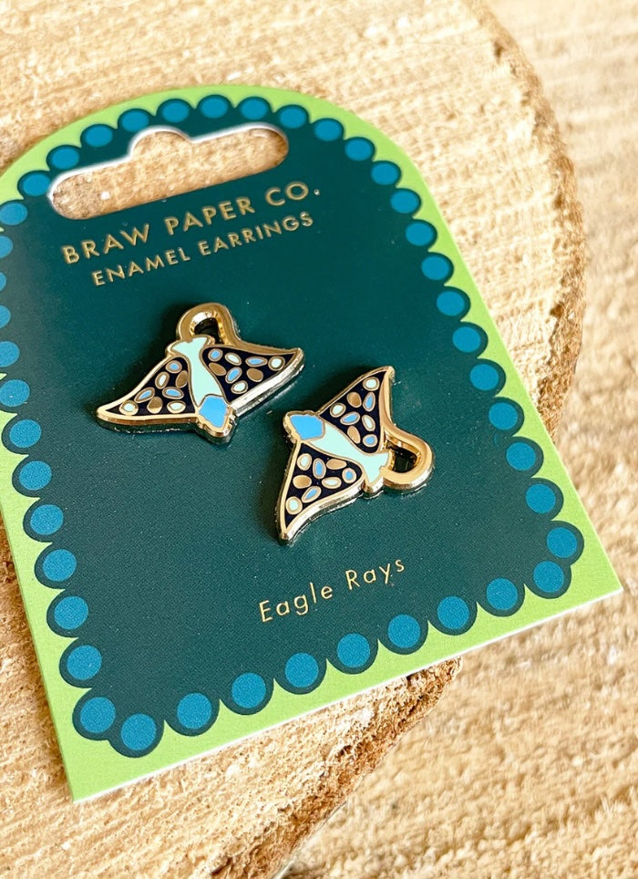 Enamel earrings shaped like eagle rays on a Braw Paper Co. card.