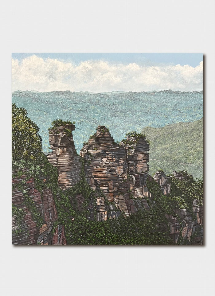 Canvas print of rock formations with trees and a blue sky.