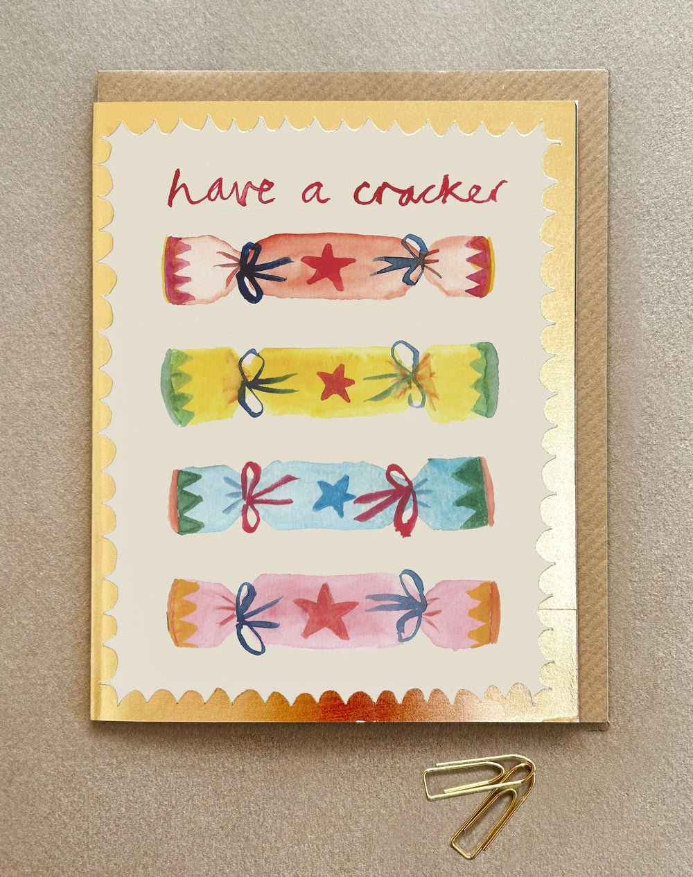 A Christmas card with colourful crackers and the words - Have a Cracker