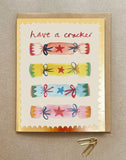 A Christmas card with colourful crackers and the words - Have a Cracker