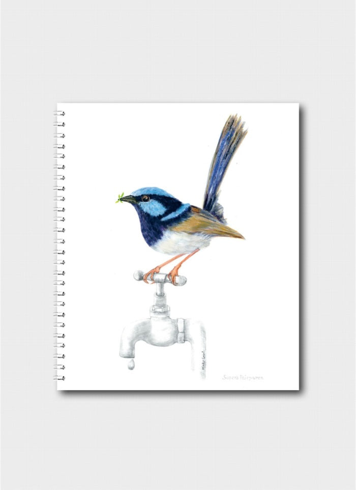 Notebook with a blue and orange bird illustration on a white background