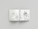 Open book with black and white illustrations on a gray background