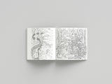 Open book with black and white line art on a gray background
