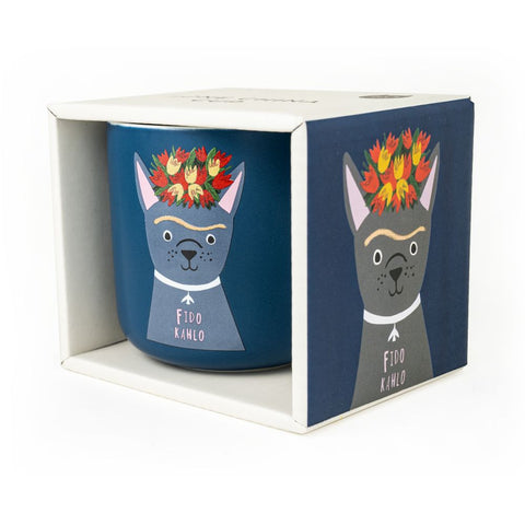 A dark blue mug with a dog called Fido Kahlo design by Niaski in it's box.