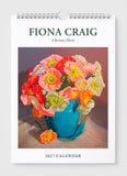 Fiona Craig 2027 calendar with a painting of flowers in a blue vase on a white background