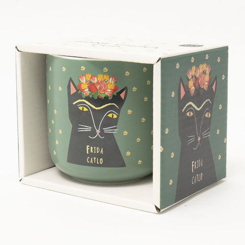 A green Frida Catlo mug in it's box - by Niaski.