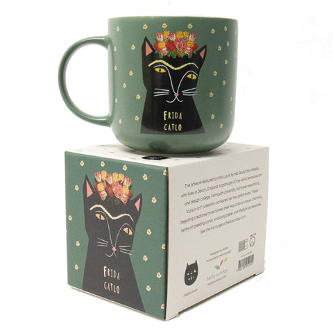 A green Frida Catlo mug on it's box - by Niaski.